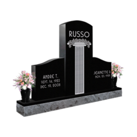 Black double headstone with engraved pillar in middle with last name 